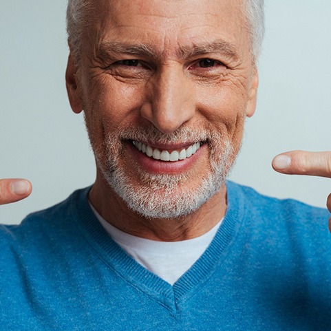 A handsome senior man isolated on a grey background
