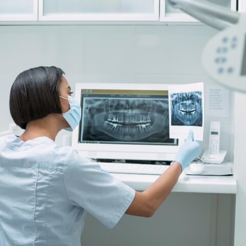 Dentist examining digital dental x-rays