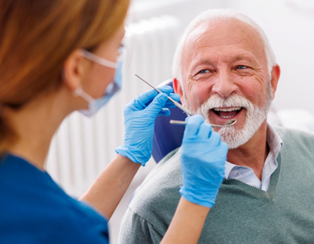 Man smiles at dentist