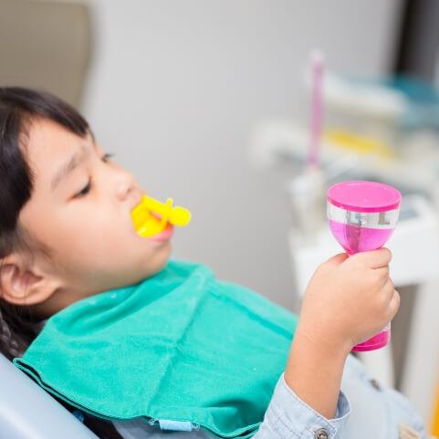 Child receiving fluoride treatment