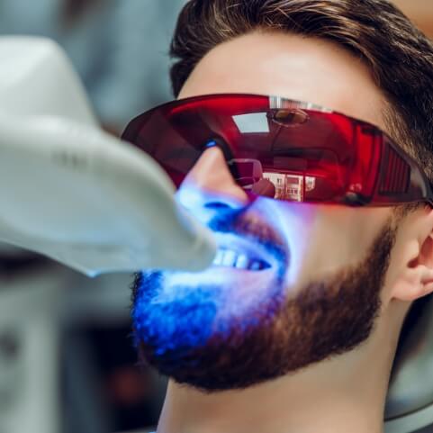Man receiving cosmetic dental bonding treatment