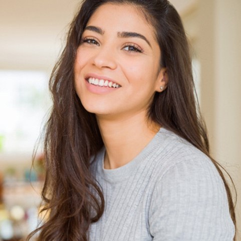 Woman with dental crown in Lewisville smiling