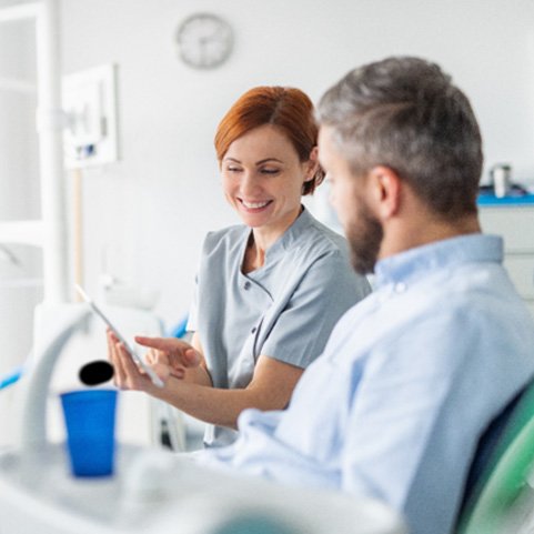 Lewisville dentist explaining dental crown process to patient