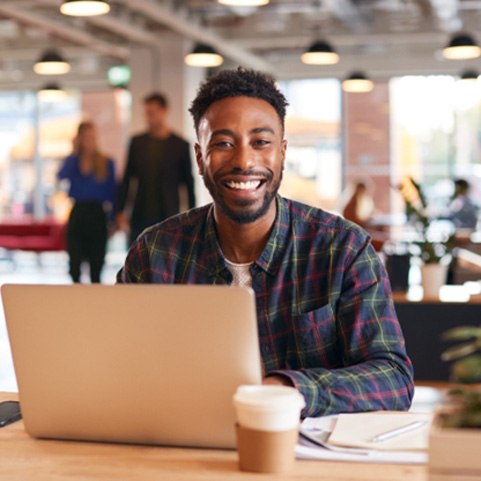 Man with dental crown smiling in office