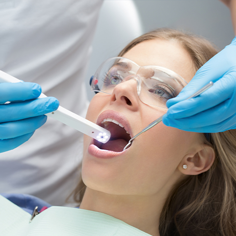 Dentist capturing images with intraoral cameras