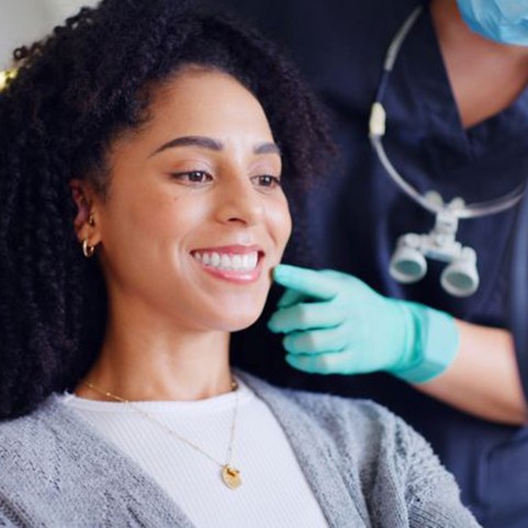 Dental patient admiring her smile in the mirror