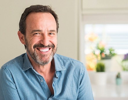 man smiling after getting dental implants