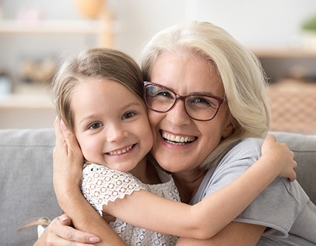 older woman smiling with grandchild 