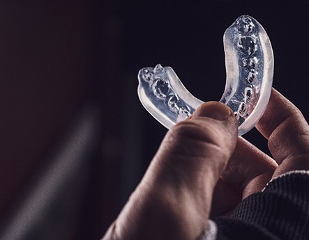 closeup of person holding mouthguard