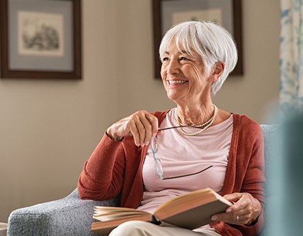 woman smiling while sitting on couch 