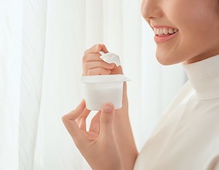 woman eating plain yogurt