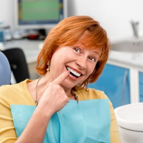 Woman with flawless smile enjoying the benefits of dental implants