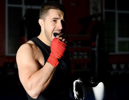 Man putting mouthguard in before martial arts class