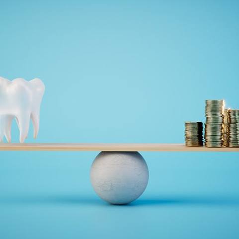 Tooth model balanced against stacks of coins