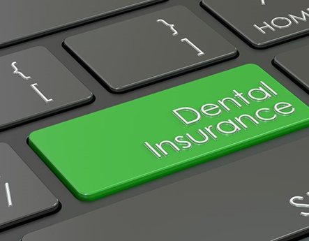 Green dental insurance key on computer keyboard