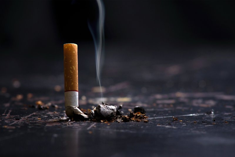 Snuffed cigarette still smolders