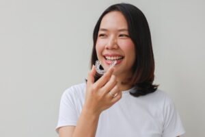 Woman putting in her clear aligners
